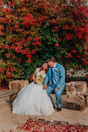 Verheiratetes Paar vor Blumen.